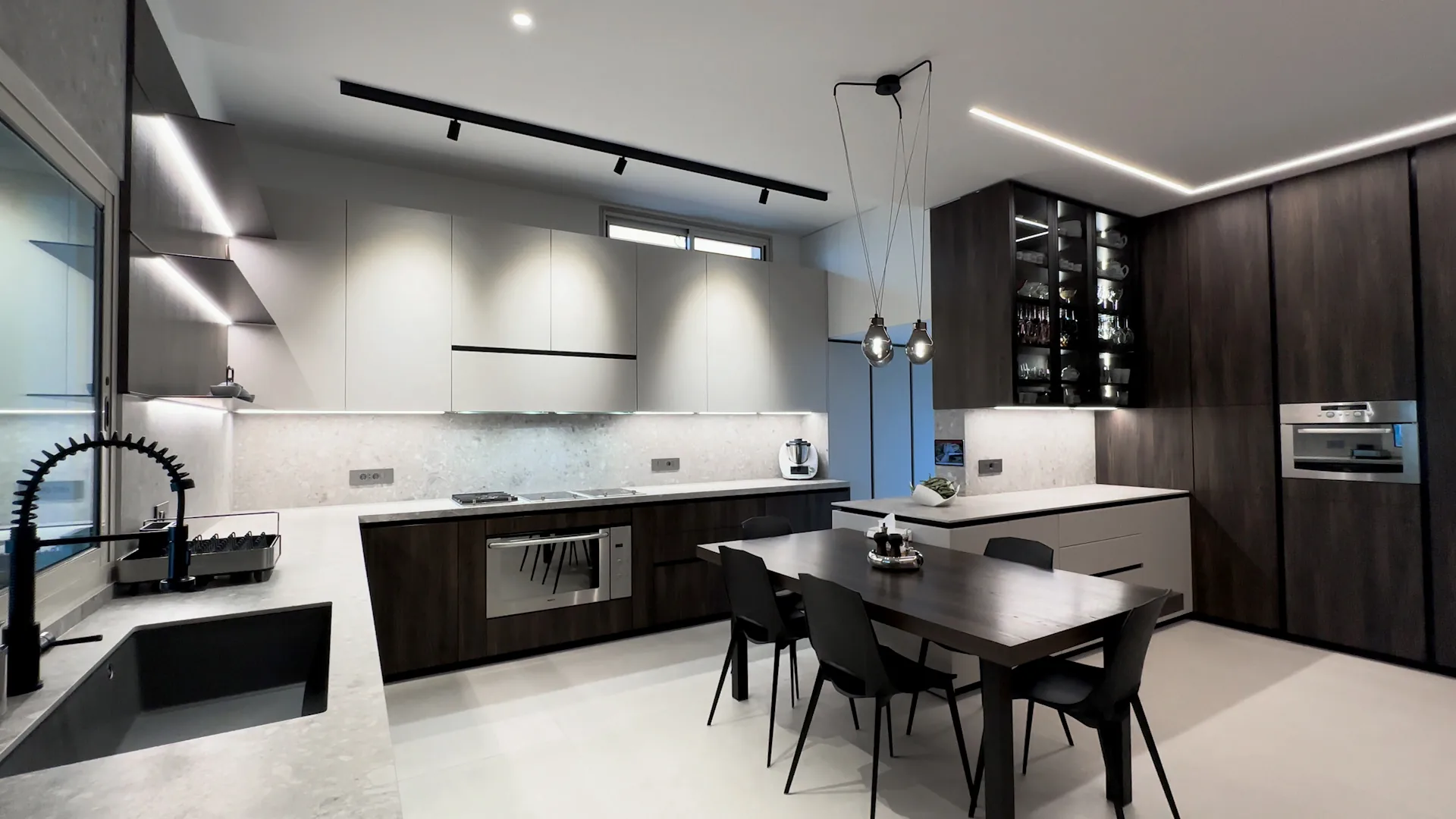 DV kitchen executed in Dbayeh, Metn — open-plan walnut and white handleless cabinetry with terrazzo backsplash and linear LED ceiling — KITWOOD completed project